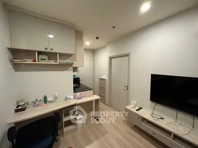 Modern compact living room with sleek furniture and mounted TV, ideal for urban living.