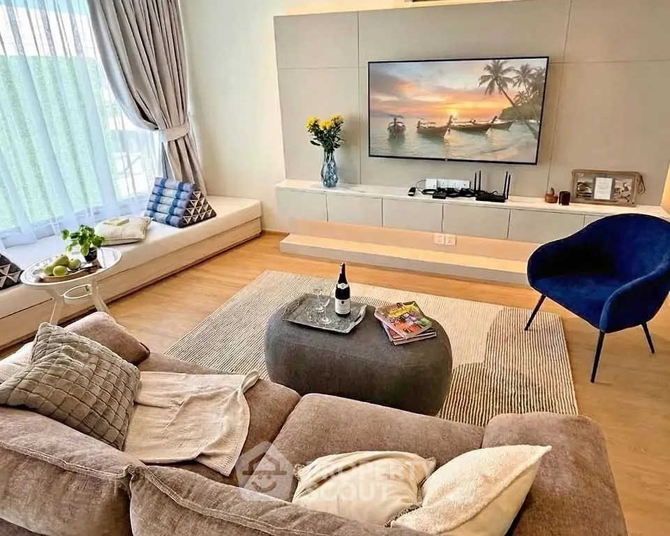 Luxurious living room with elegant decor, plush seating, and large TV, perfect for relaxation and entertainment.