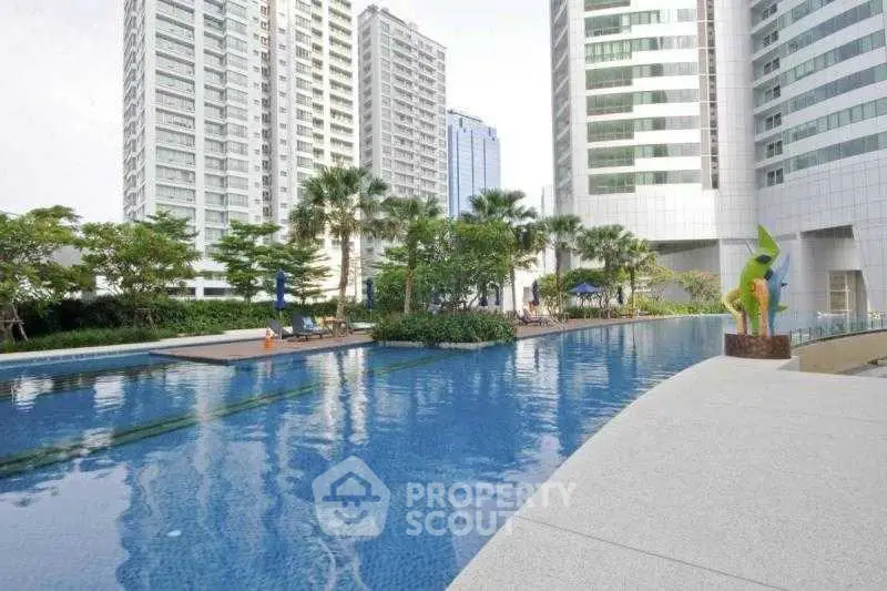 Luxurious high-rise residential pool area with modern architecture and lush greenery.