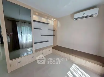 Modern living room with built-in shelves and air conditioning