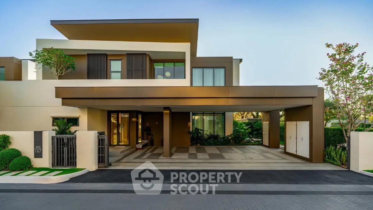Luxurious modern villa with sleek design and spacious driveway in upscale neighborhood.