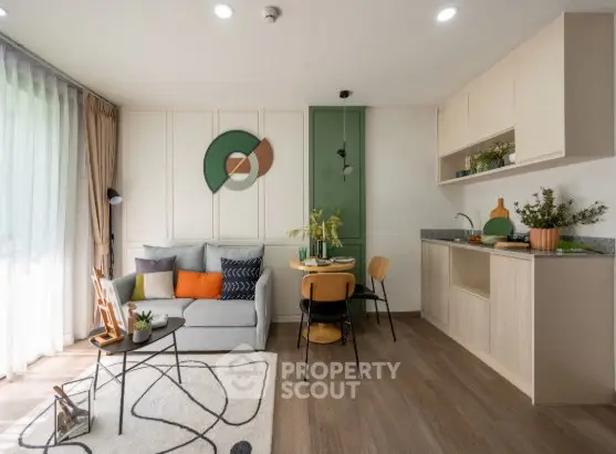 Modern living room with open kitchen, stylish decor, and natural light