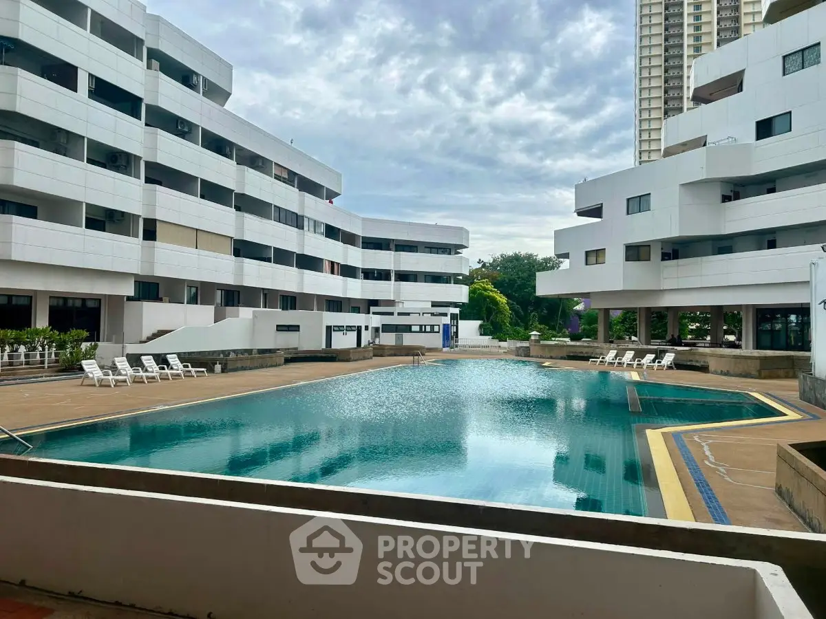 Luxurious residential complex with a stunning outdoor pool and modern architecture.