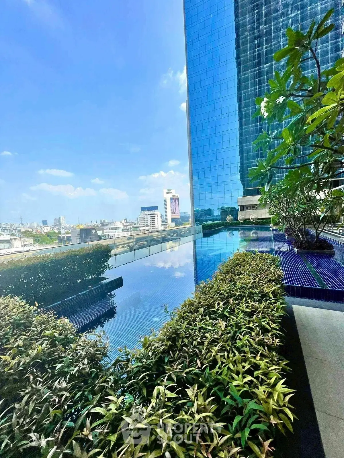 Luxurious rooftop pool with stunning city views and lush greenery.