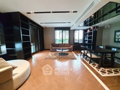 Luxurious modern living room with elegant furnishings and large windows offering natural light.