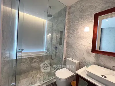 Luxurious marble bathroom with glass shower and modern fixtures