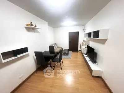Modern living room with sleek furniture and wall-mounted shelves in a cozy apartment.