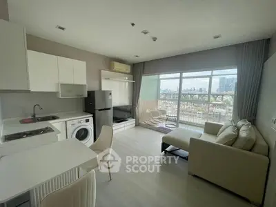 Modern open-plan living room with kitchen, featuring city view and stylish furnishings.