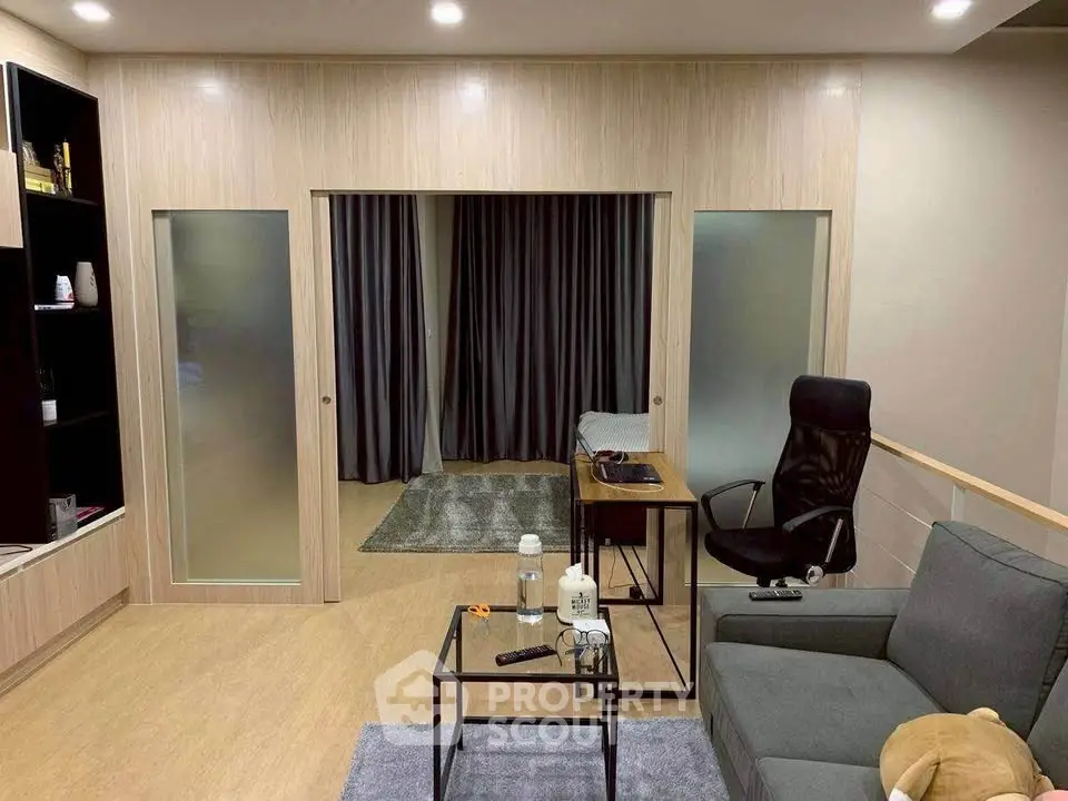 Modern living room with stylish furniture and sliding doors, perfect for cozy relaxation.