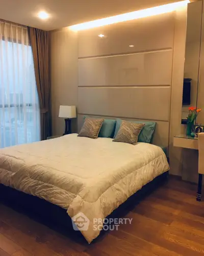 Elegant bedroom with cozy bedding and modern decor in a stylish apartment.