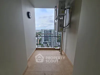 Spacious balcony with stunning city view in modern high-rise apartment.