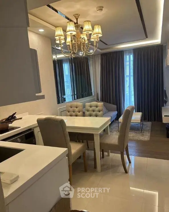 Elegant living room with chandelier and modern furniture in a stylish apartment.