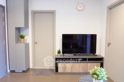 Modern living room with sleek TV stand and minimalist decor, perfect for cozy relaxation.
