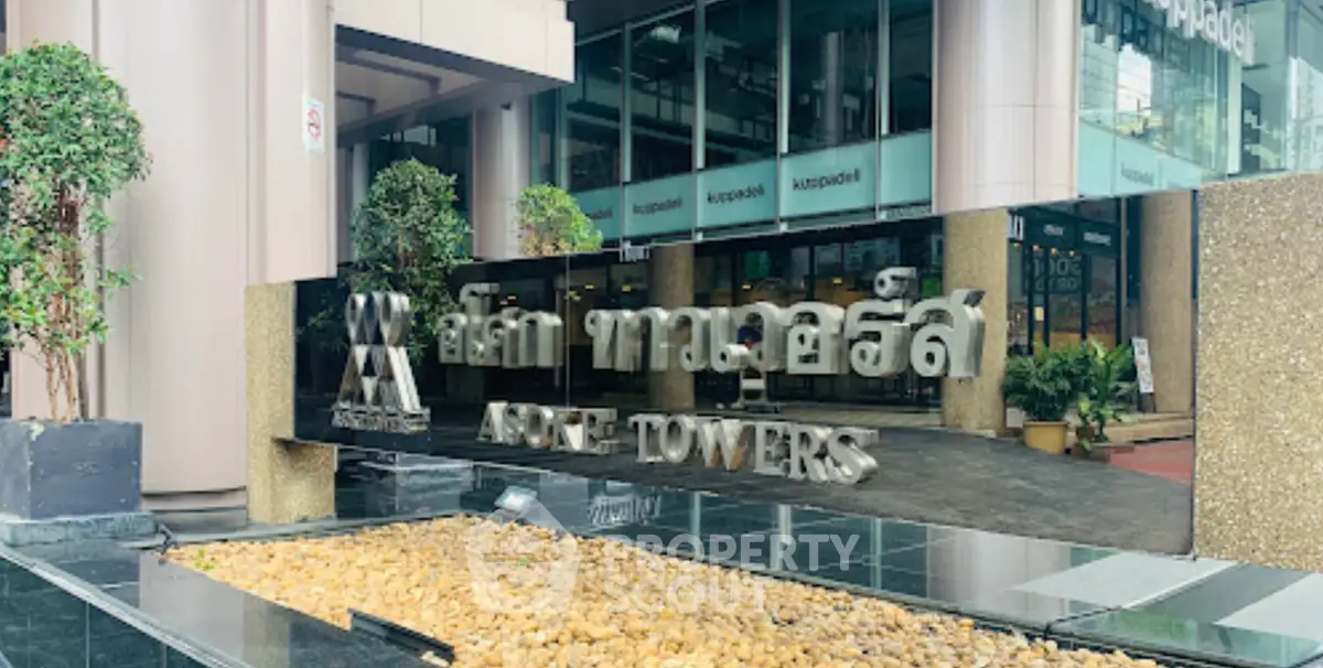 Modern entrance of Aspire Towers with sleek design and reflective surfaces.