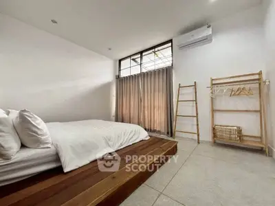 Minimalist bedroom with platform bed and natural light