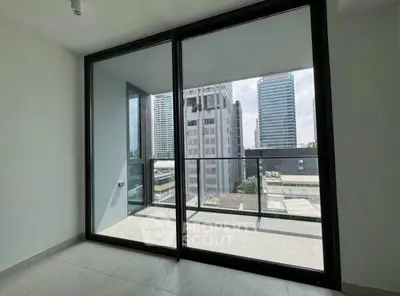 Modern apartment with floor-to-ceiling windows and city view balcony.