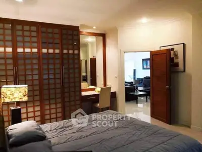 Spacious bedroom with elegant wooden sliding doors and a cozy ambiance.