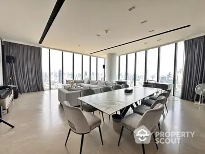 Luxurious modern living room with panoramic city views and elegant dining area