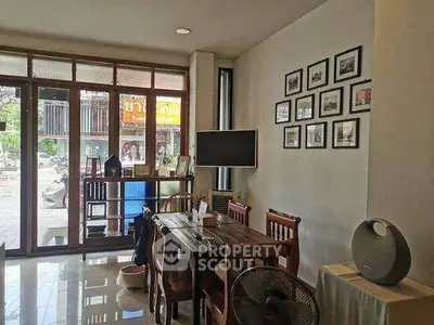 Charming living room with wooden furniture and wall art, perfect for cozy gatherings.