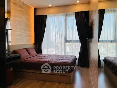 Modern bedroom with large windows and stylish decor in high-rise apartment.