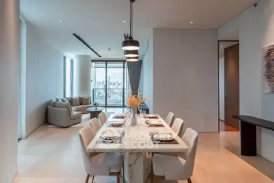 Luxurious open-plan dining and living area with city view, modern furnishings, and elegant decor.