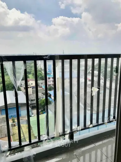 Spacious balcony with panoramic city view, perfect for relaxation and enjoying the skyline.