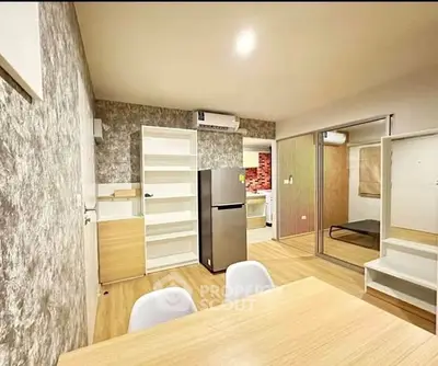 Modern open-plan living area with stylish decor and integrated kitchen appliances.