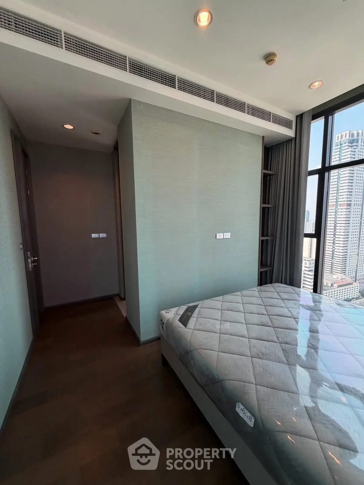 Modern bedroom with city view and sleek design in high-rise apartment