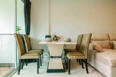 Elegant dining area with modern table and chairs in a cozy living room setting.
