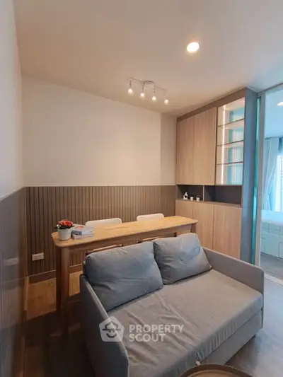 Modern living room with cozy sofa and dining area in stylish apartment