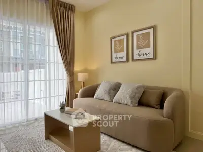 Cozy living room with modern beige sofa, elegant curtains, and stylish decor.