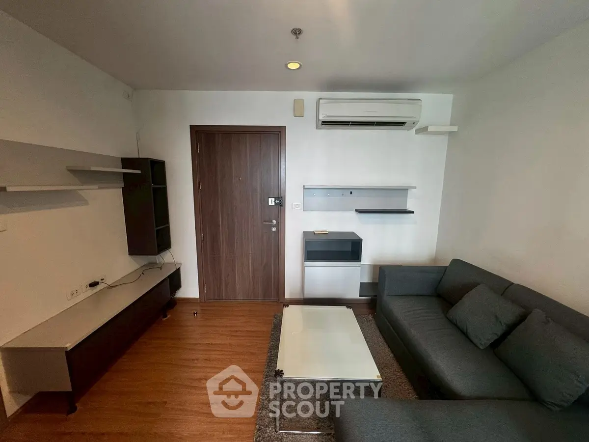 Modern living room with sleek furniture and air conditioning in a cozy apartment.