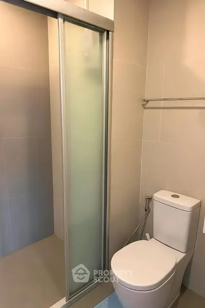 Modern bathroom with sleek shower and toilet design