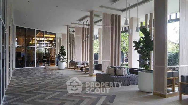 Elegant modern lobby with stylish seating and large windows, perfect for welcoming guests.