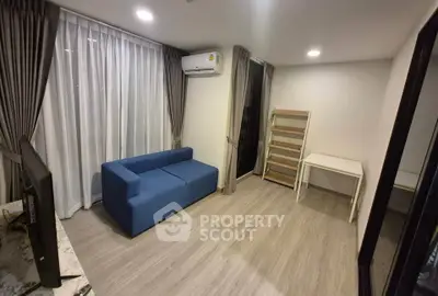 Modern living room with blue sofa and air conditioning in a cozy apartment.