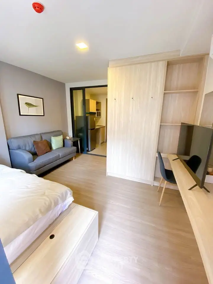 Modern studio apartment with cozy living area and sleek furniture, perfect for urban living.