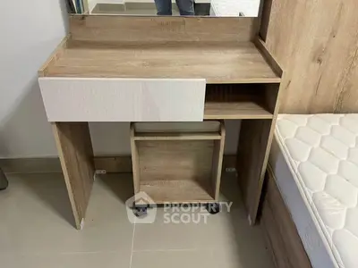 Modern wooden vanity desk with mirror and mattress in a stylish bedroom setting.