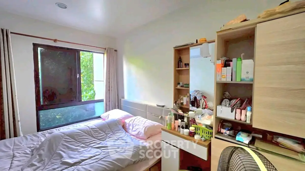 Cozy bedroom with natural light and organized storage space