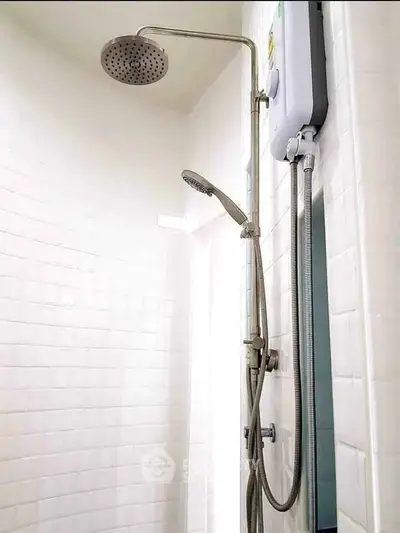 Modern bathroom shower with sleek fixtures and white tiled walls