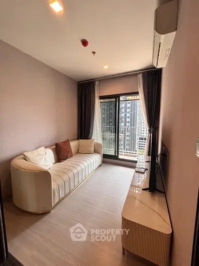 Modern living room with stylish sofa and balcony view in high-rise apartment