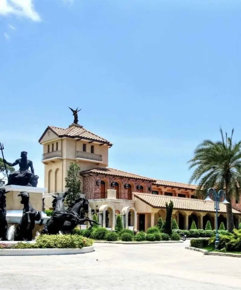 Stunning Mediterranean-style villa with elegant statues and lush landscaping