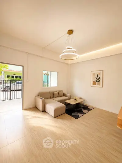 Bright and modern living room with stylish lighting and cozy seating area.
