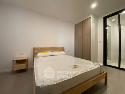 Modern minimalist bedroom with wooden bed frame and built-in closet