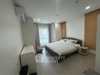 Spacious bedroom with modern decor and natural light