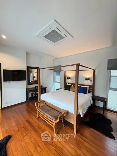 Luxurious bedroom with elegant wooden flooring and modern decor