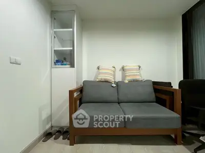 Cozy living room with modern sofa and storage cabinet, perfect for urban living.