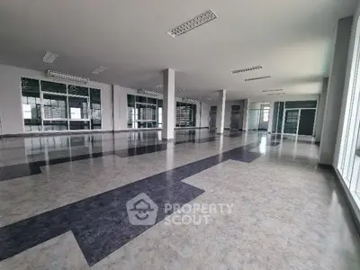 Spacious open-plan commercial space with modern flooring and ample natural light.