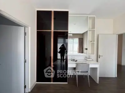 Modern bedroom with sleek wardrobe and stylish study area, perfect for contemporary living.