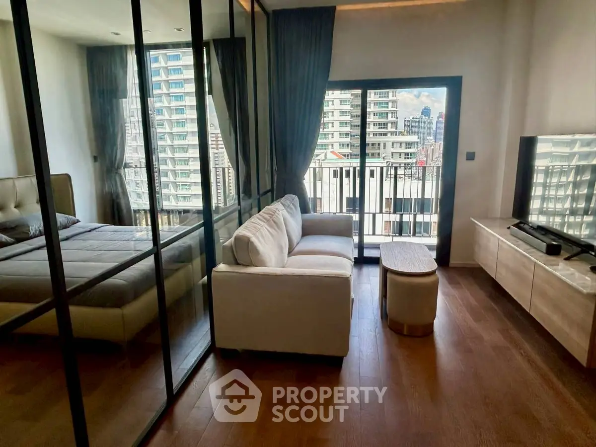 Modern studio apartment with glass partition and city view balcony
