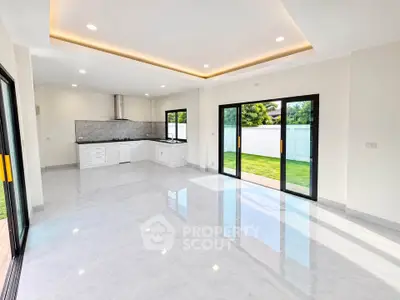 Spacious open-plan living room with modern kitchen and garden view